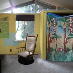 If I can find good fabric (and can work out the logistics), my idea was to make a wall pocket to hold toys. The curtain and chair came from other photos.